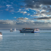 Szent Miklós motoroshajó a vitorlások között a Balatonon